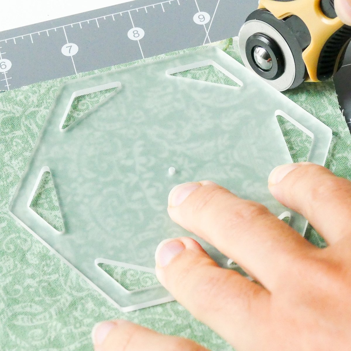 Rotary cutting around a hexagon template with rotary cutter