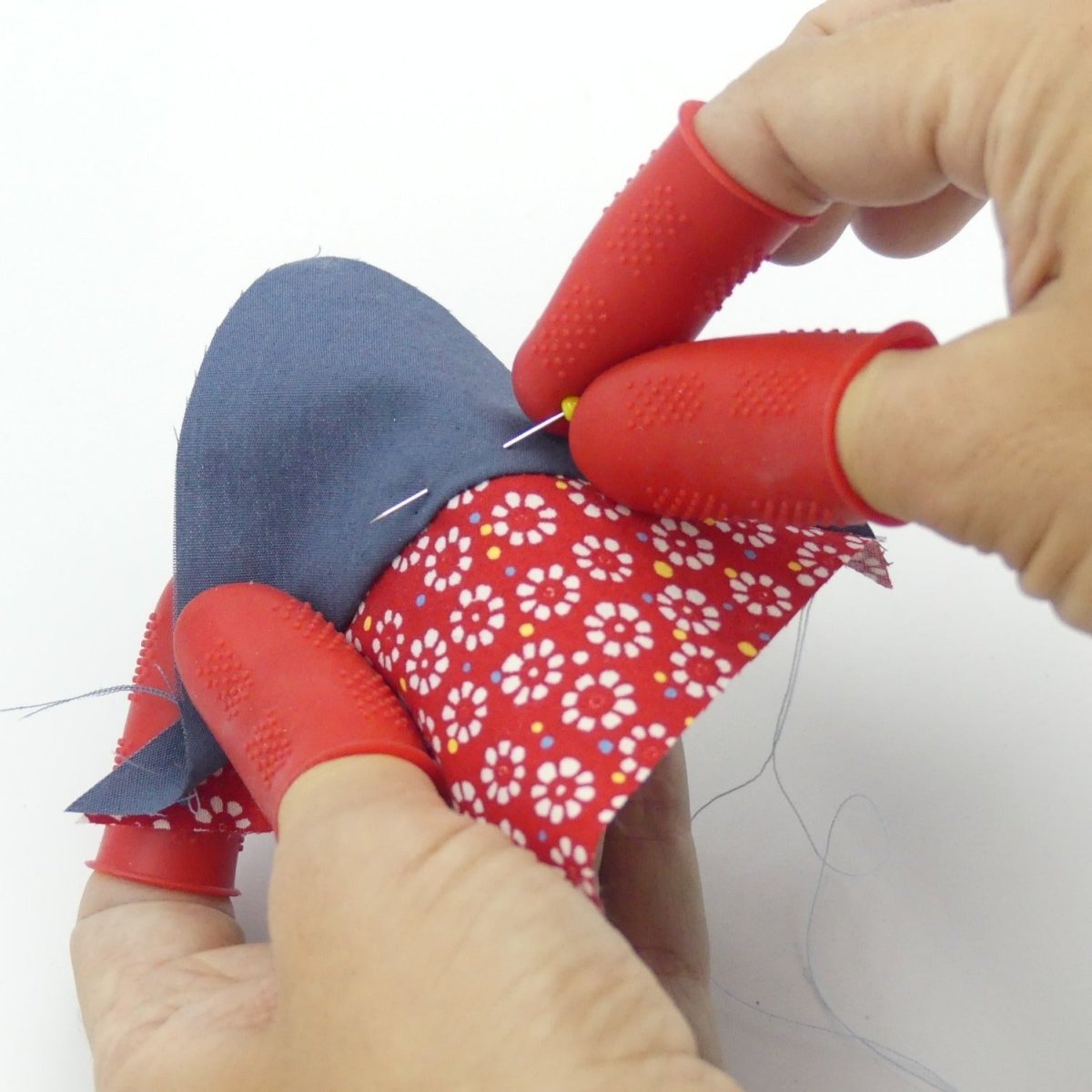 Picture shows how flexible the Ironing thimbles are...you don't even have to take them off to do a little hand sewing