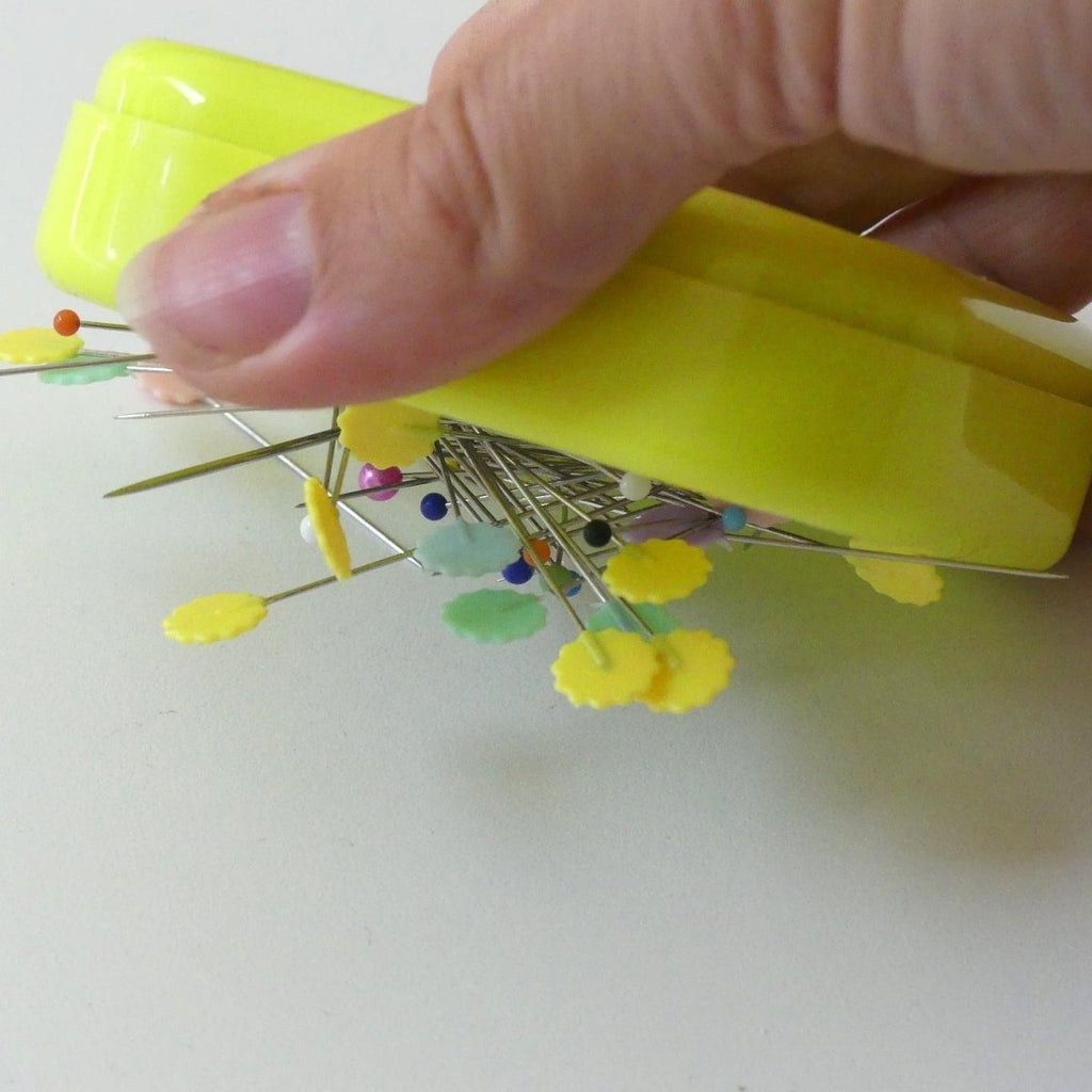 Magnetic Pin Cushion shown holding pins and picking pins up.