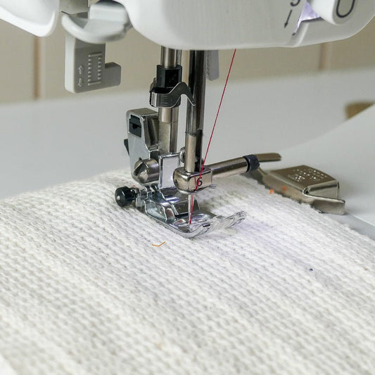 magnetic seam guide guiding a fabric to sew a straight line