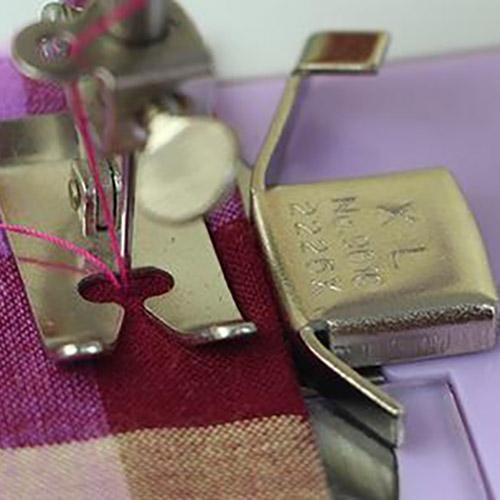 magnetic seam guide on a sewing machine next to a presser foot