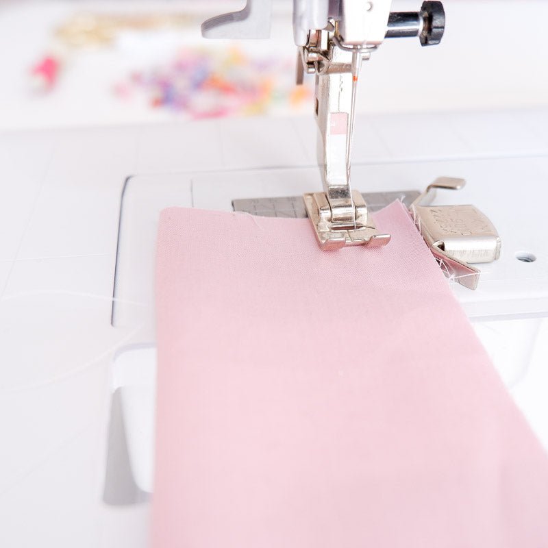 magnetic seam guide on a sewing mzchine with a pink fabric