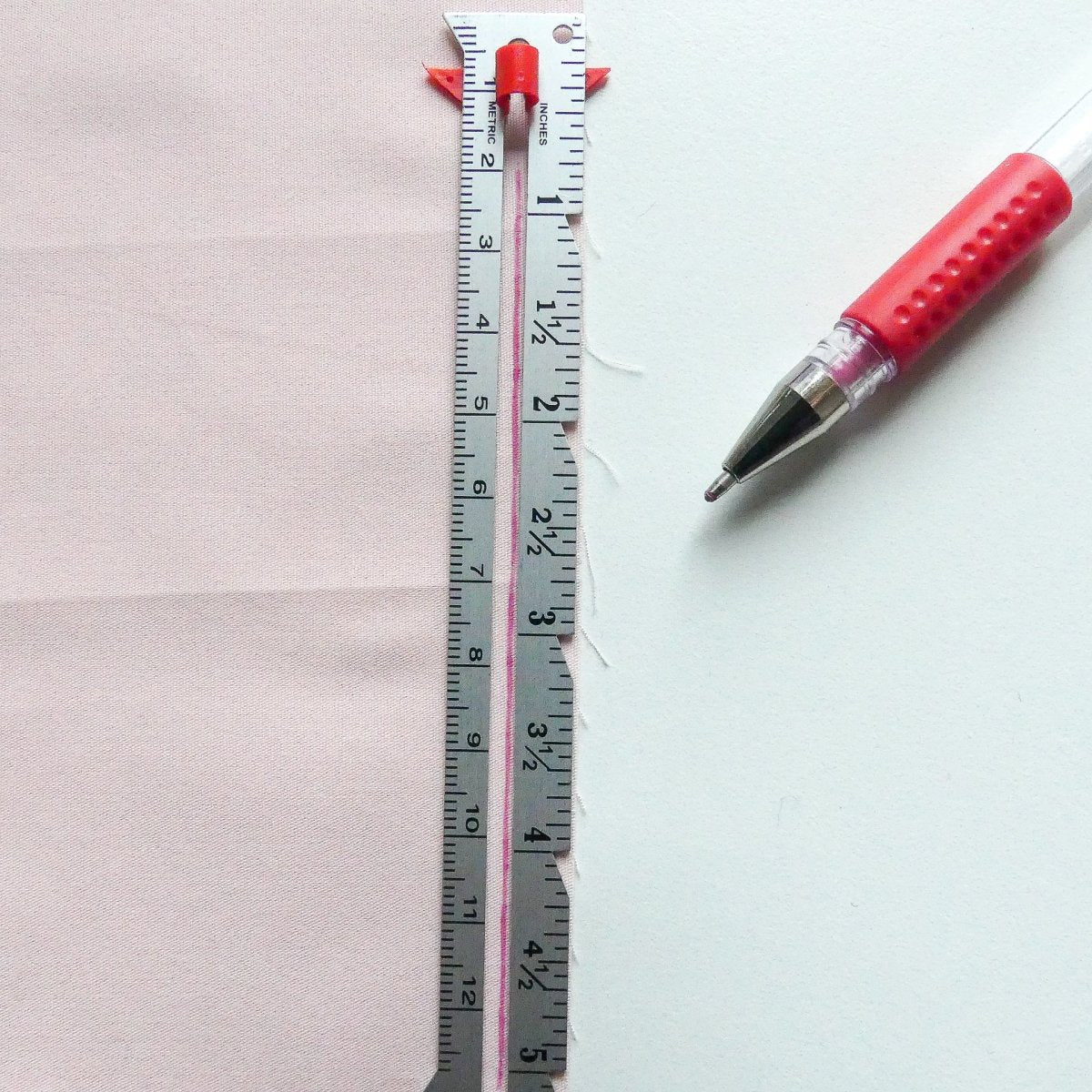 Marking hems on fabric with the measuring gauge and a heat erasable marking pen