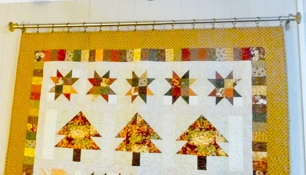 A quilt on the wall using Metal Curtain & Quilt Hangers