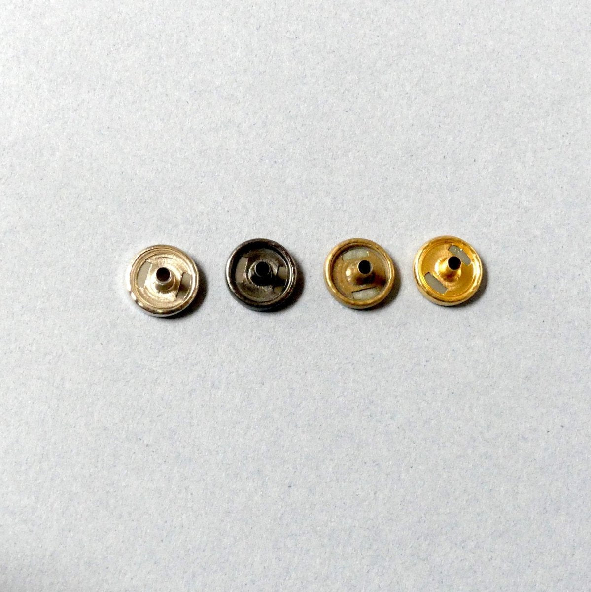4 different colors of metal snap buttons