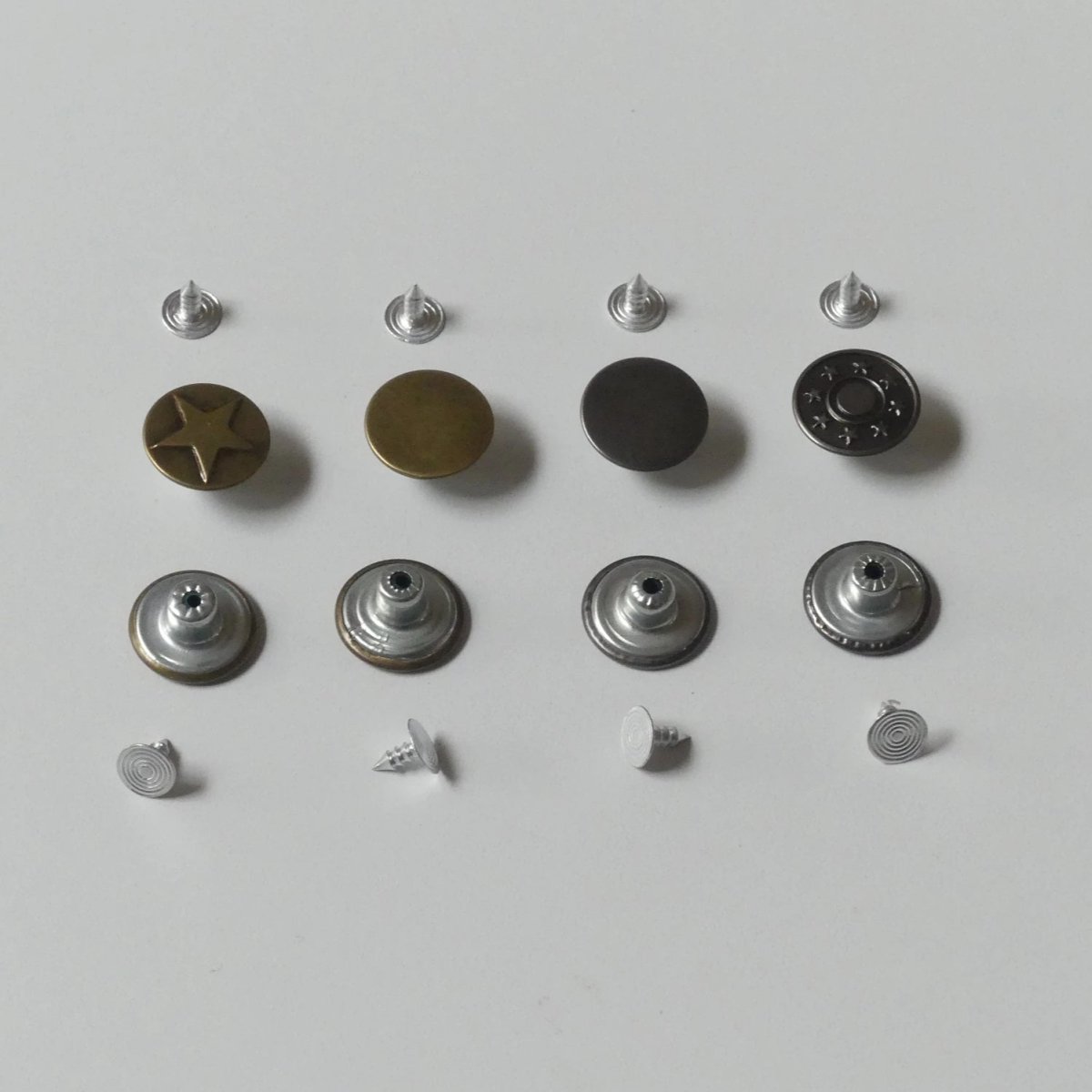 different parts of the metal snap button set in a row