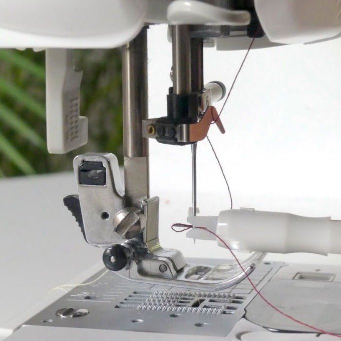 Inserting a thread on a sewing machine needle with the Needle threaders