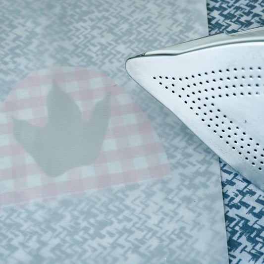 non stick pressing sheet on a piece of HT with a hot iron