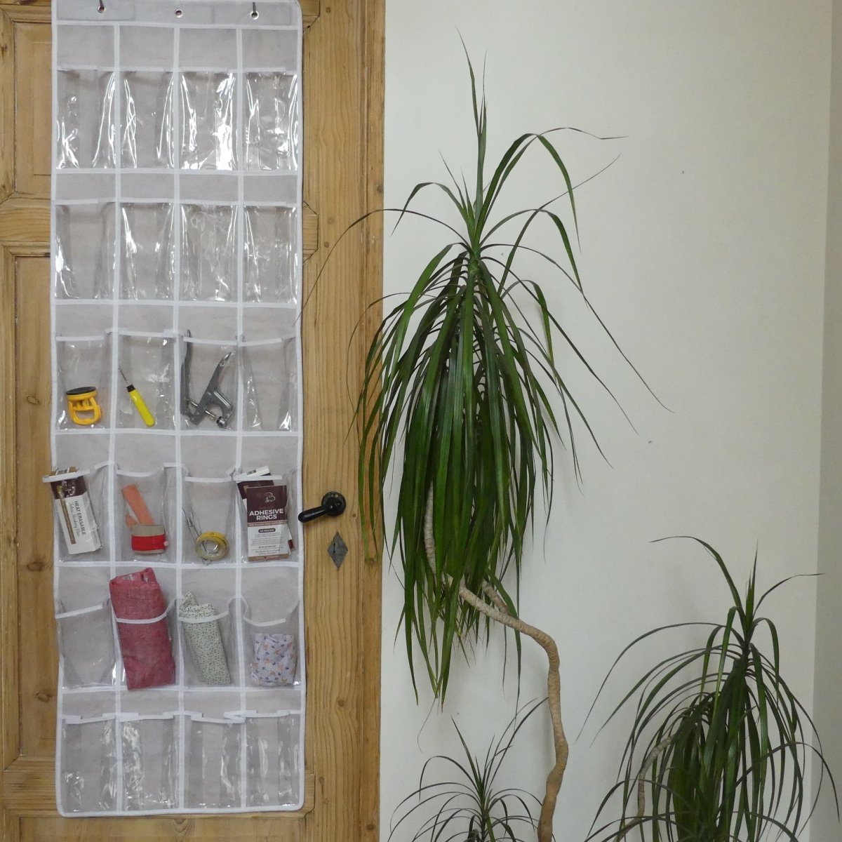 Craft Room Storage with an Over The Door Organizer hanging on the door