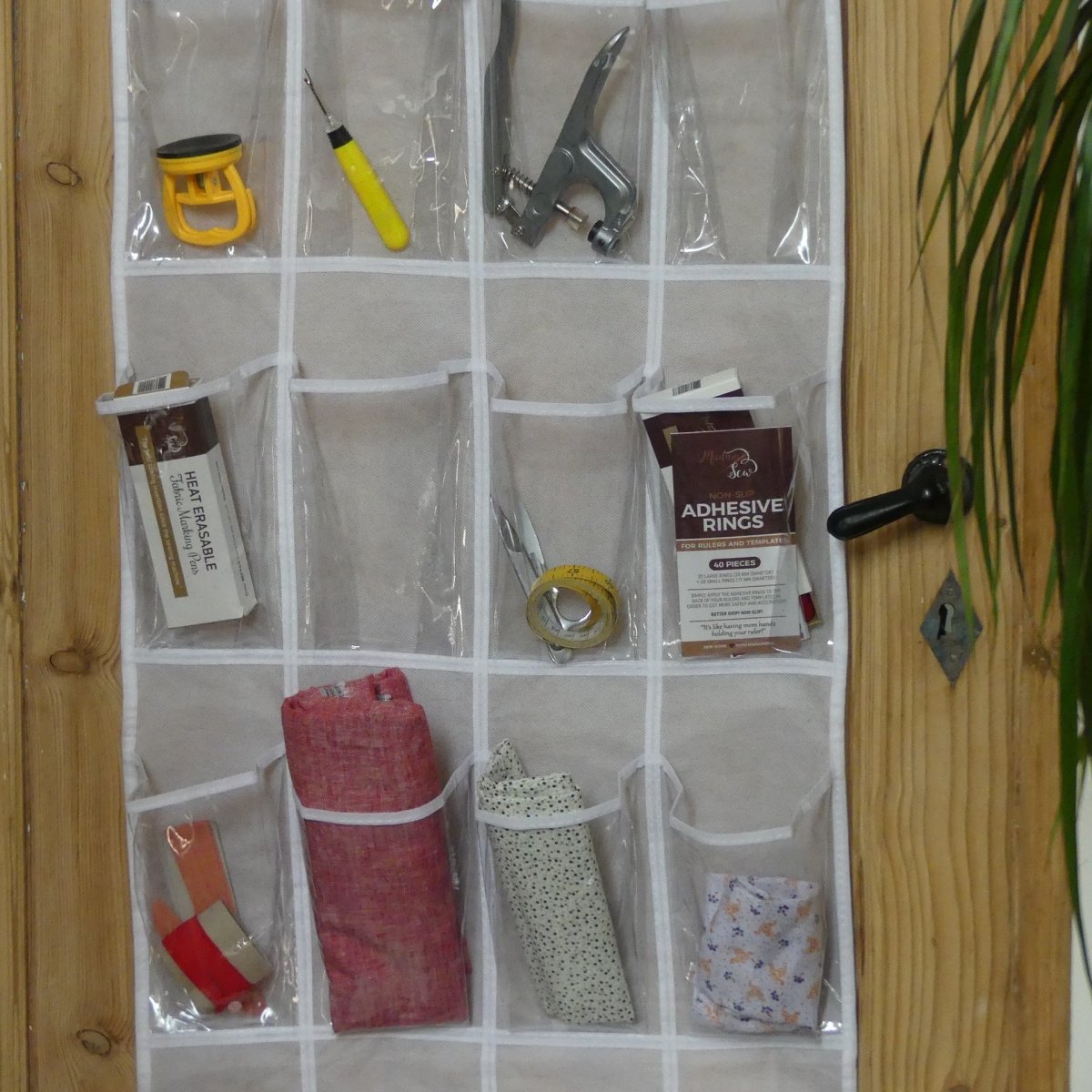An Over The Door Organizer with sewing tools
