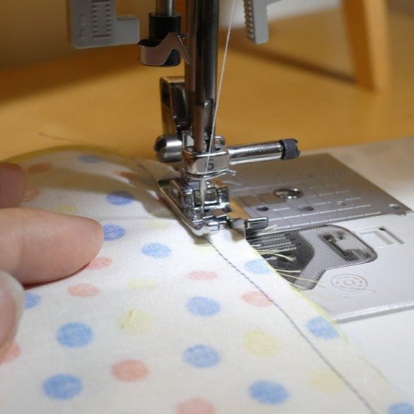 the overcast foot on a sewing machine finishing the seam of 2 joint fabrics