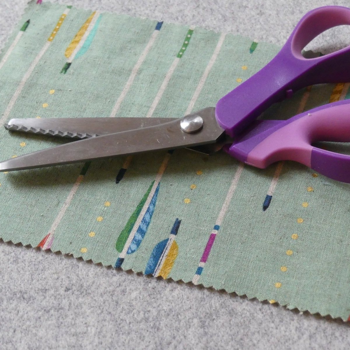 pinking shears on a piece of fabric with a zigzag edge