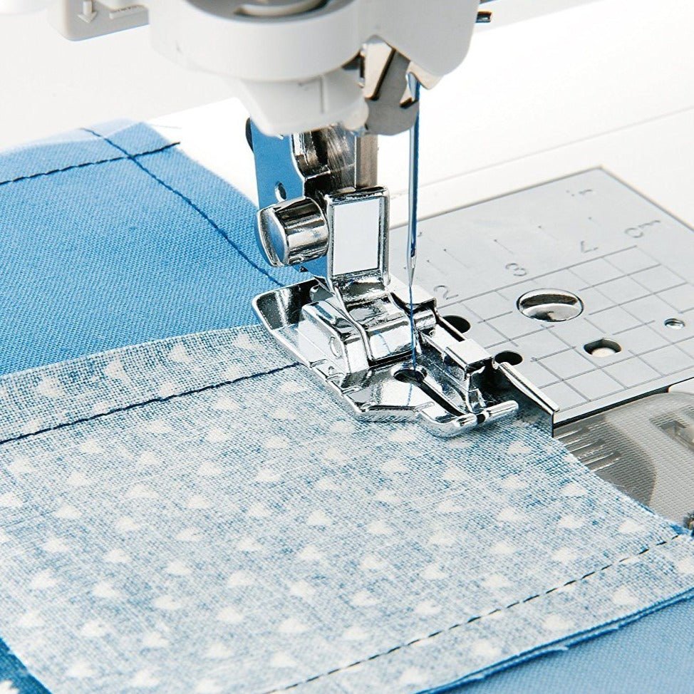 Picture showing the 1/4" Quilting Foot with Guide being used  to line up fabric for a perfect 1/4" seam.