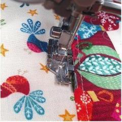 Picture showing the 1/4" quilting foot with guide being used to make straight topstitching.