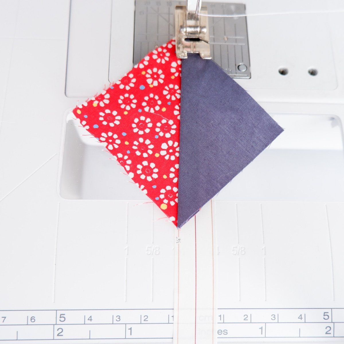 Sewing while using the Quarter Inch Seam Tape as a guide