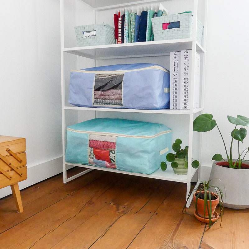 Quilt storage bags in a cupboard