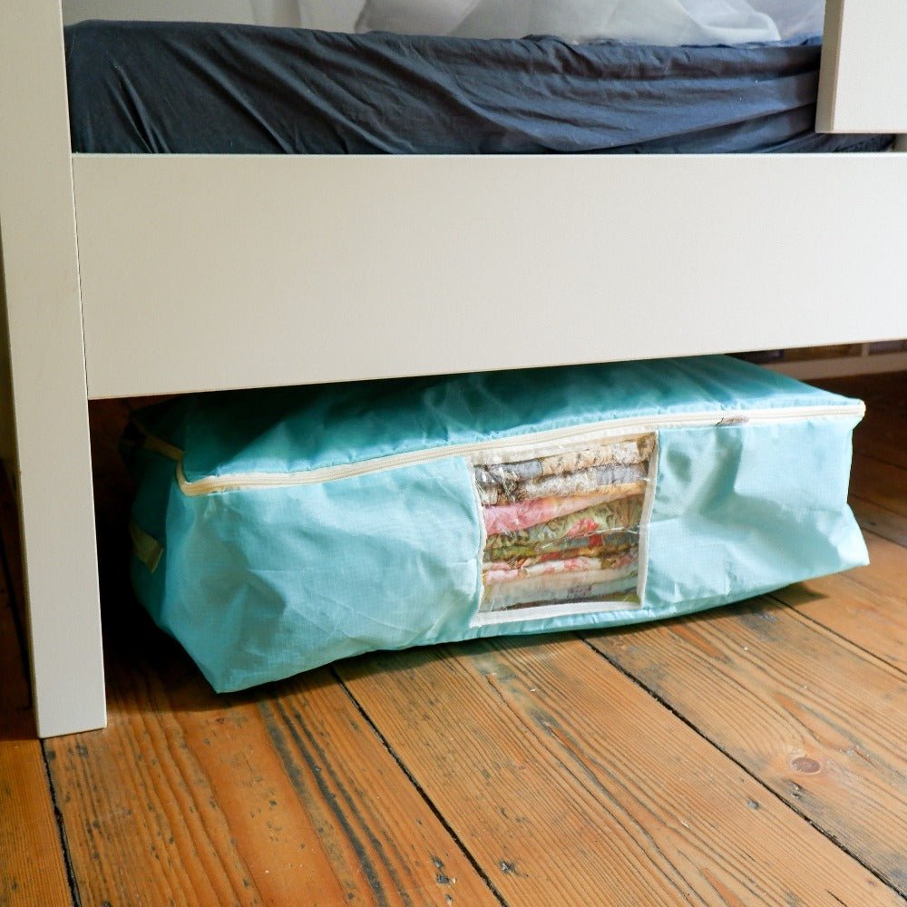 Turquoise quilt storage bag that fits under a bed