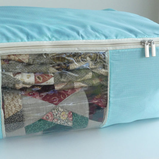 Turquoise Quilt Storage Bag with a window showing folded quilts