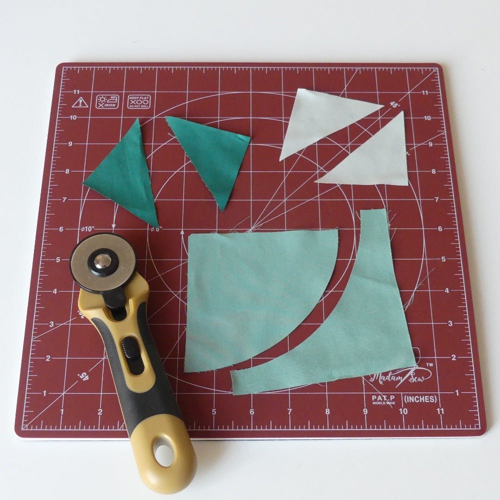 Cutting  fabric pieces with a rotary cutter on a rotating cutting mat