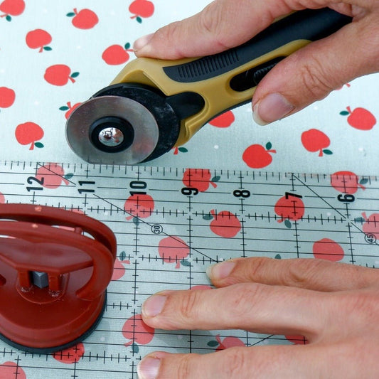 cutting fabrics with a rotary cutter with a ruler