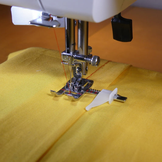 a presser foot with a guide to sew straight next to a seam