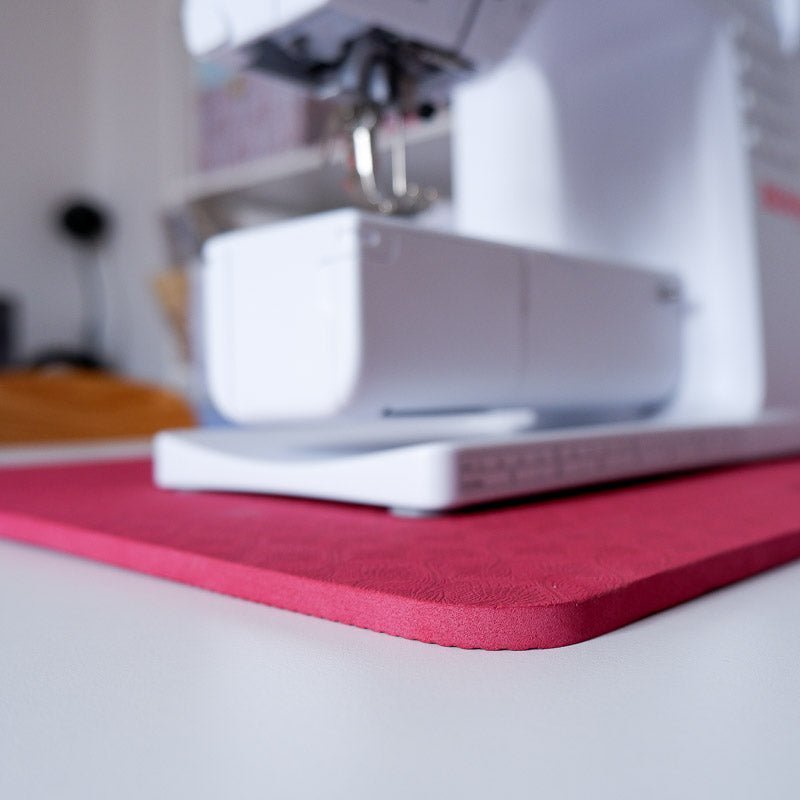 Detail of the Madam Sew Sewing Machine Muffling Mat under a white sewing machine