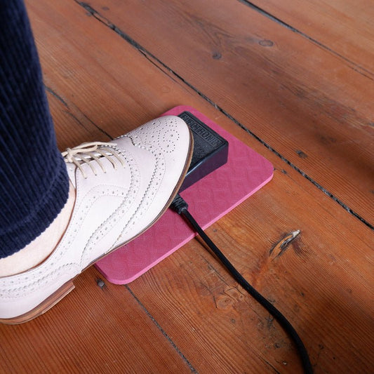 MadamSew Sewing Machine Pedal Mat being used on a wood floor.