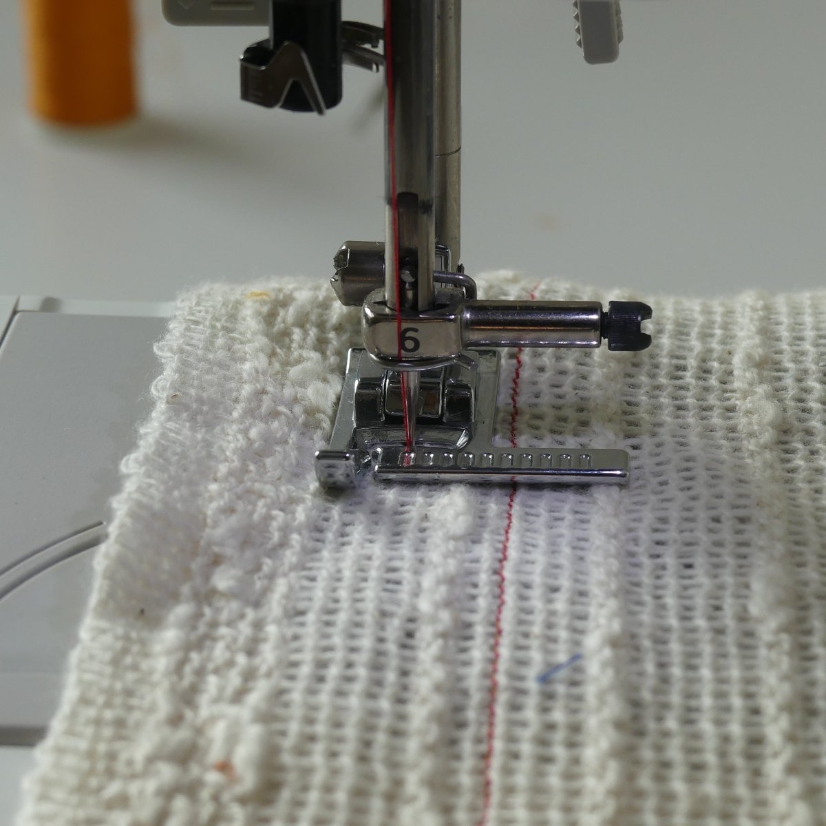 Topstitching with a Ruler Foot on white fabric