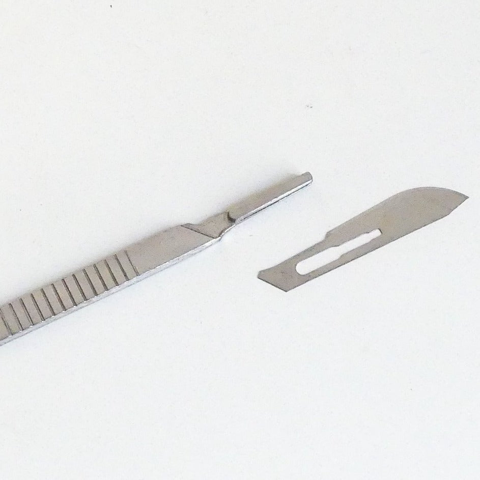 The thread knife with a spare blade next to it