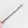A hand holding the thread knife of the bird nest toolkit with a new blade attached