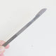 A hand holding the thread knife of the bird nest toolkit with a new blade attached