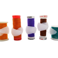 Spools with sewing thread and spool huggers to keep sewing thread from unraveling
