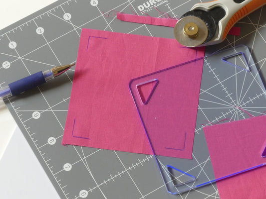 A square of fabric that has been marked and cut using a Square Template