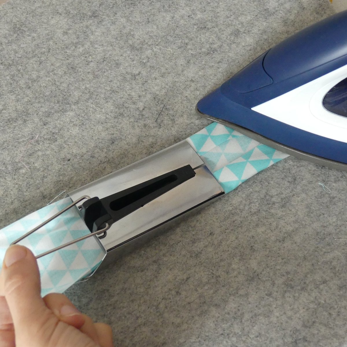 Ironing bias tape as it comes out of the Extra Large (XL) Bias Tape Maker