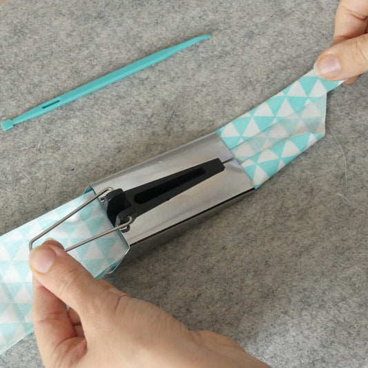 Pulling the pointed end of fabric through the Extra Large Bias Tape Maker
